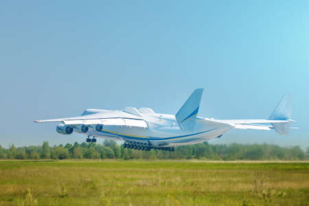 Huge cargo plane taking off, blue skyの写真素材