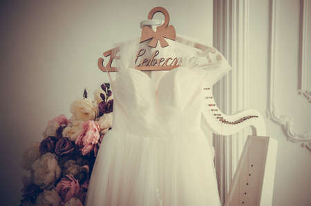 wedding dress hanging on racks, text means - Bride