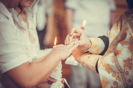 The exchange of rings during an Orthodox wedding, the priest puts rings to bride and groom, wedding...