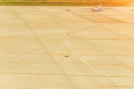 passenger airplane is landing to runway of airport, trees on backgroundの写真素材