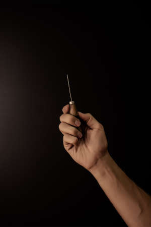 Hands holding leather craft object with tool using for manufactureの写真素材