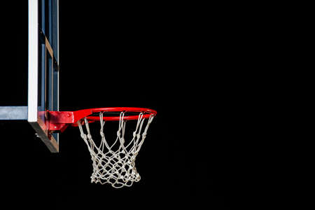 Red basketball hoop isolated on black. Basketball ring. With copy space.の写真素材