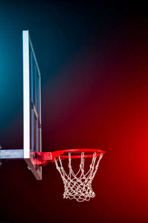 Basketball hoop isolated on black. Lightened by mixed color lights.の写真素材