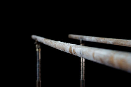 Closeup. Talcium powder over gymnastic parallel bars. Gymnastic parallel bars. Isolated on black background,の写真素材