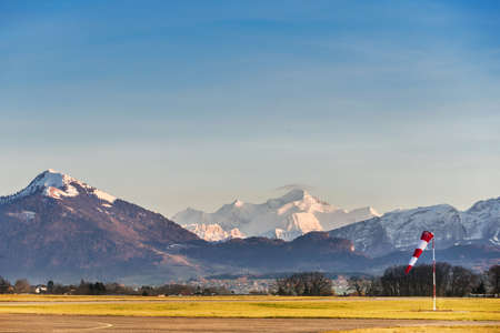 Small airfield in front of mountain top. Sunset over mountains.の写真素材