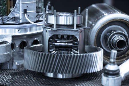 Ekectric car drivetrain parts during maintenance. Blue toned.の写真素材