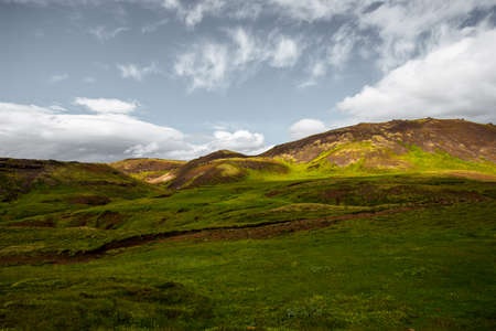 Wonderful icelandic nature landscape. View from the top. High mountains, mountain river and green grassland. Green meadows. Iceland.の写真素材