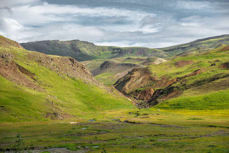 Wonderful icelandic nature landscape. View from the top. High mountains, mountain river and green grassland. Green meadows. Iceland.の写真素材