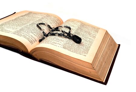 The old book with a beaded ornament on a turn of pagesの写真素材