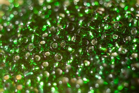 Background from the green beads scattered on an equal surfaceの写真素材