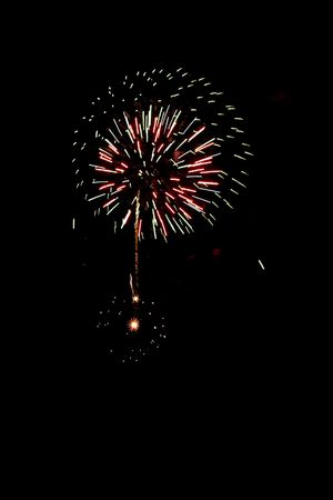 Multi-coloured fires inflame in the night skyの写真素材