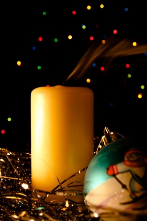 The smoke rises from a match of a candle, beside in a tinsel the New Yearの写真素材