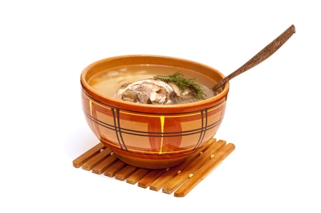 Fish soup in a clay plate on a white backgroundの写真素材