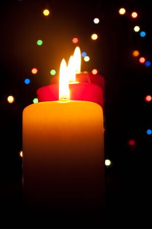 Three burning candles on a dark abstract background の写真素材