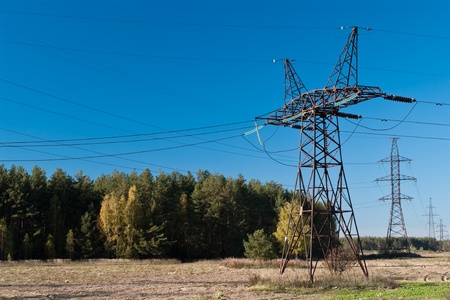 High-voltage electric main on a background of the clear dark blue sky の写真素材