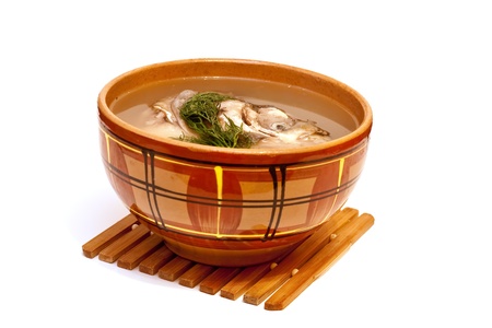 Fish soup in a clay plate on a white background の写真素材