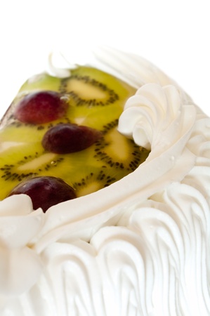 Pie with whipped cream and fruit in jelly on a white backgroundの写真素材