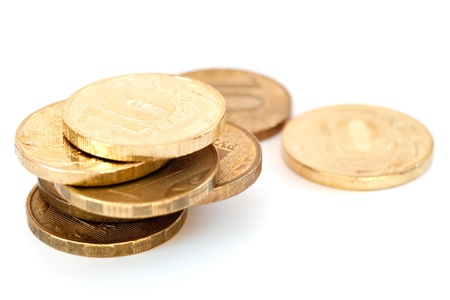 Some coins of yellow metal on a white backgroundの写真素材