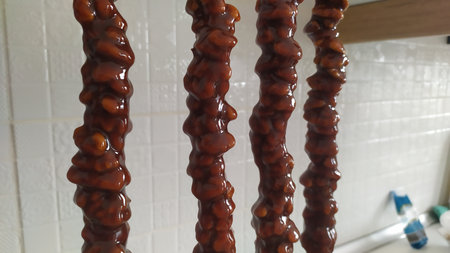 Close-up of caramel candies hanging on the wall in the kitchenの写真素材