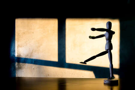 Wooden man is waiting to write something for his wall.の写真素材