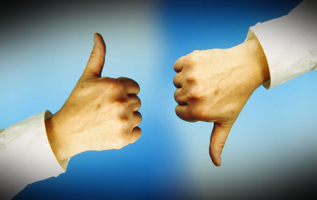 One hand with thumbs up, another with thumbs down. Blue background.