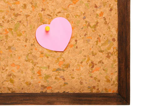 Cork board with heart shape sticky noteの写真素材