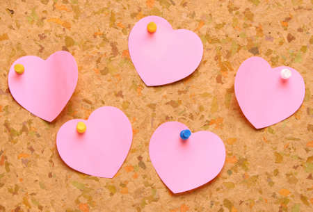 Cork board with heart shape sticky notesの写真素材