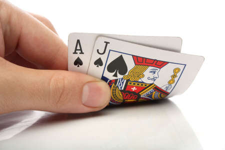 Blackjack. Human hand with blackjack cards over whiteのeditorial素材