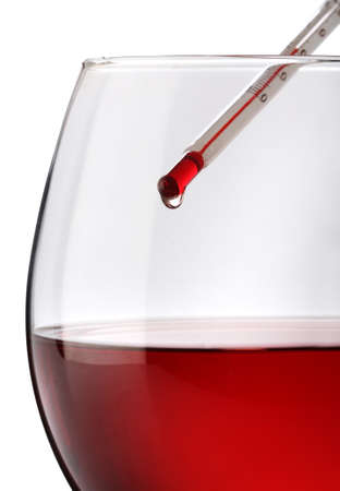 Red wine temperature. A thermometer on a wine glassの写真素材
