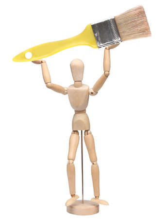 wood mannequin holding a brush over whiteの写真素材