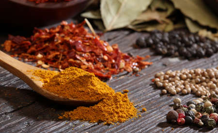 Different spices over a dark wood  Selective focus 