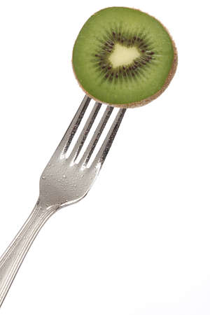 Grenn kiwi on a fork isolatedの写真素材