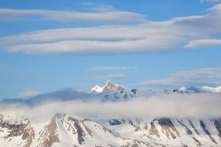 Mountain winter landscape with cloudsの写真素材