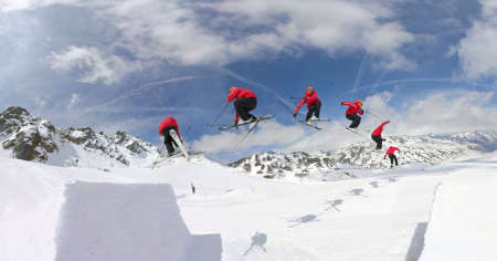 Freestyle skier jumps and grabs skisの写真素材