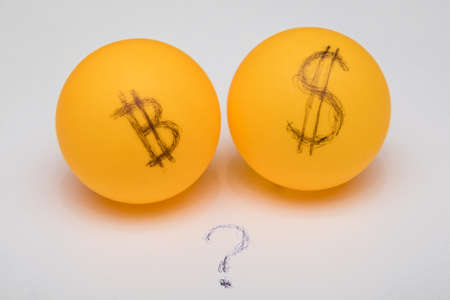 Balls with bitcoin and dollar. Question mark between them.の写真素材