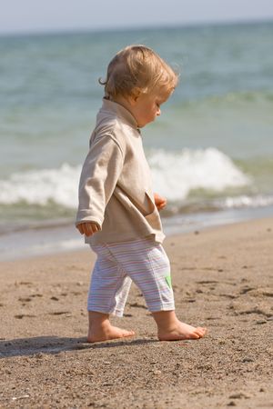 Young boy (one year old) on beachの写真素材