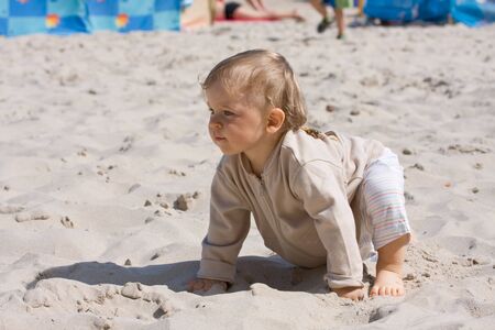 Young boy (one year old) on beachの写真素材