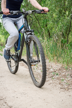 A trip on a mountain bike along the forest path. Sports and the concept of active life in the summerの写真素材