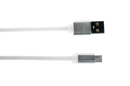 Two gray connectors of white micro USB cable on white isolated background.の写真素材