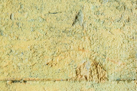the texture of the old yellow boiled wall to the full screenの写真素材
