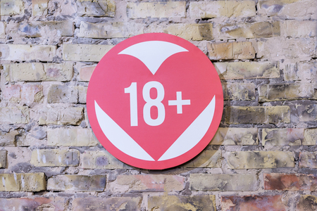 the sign of the heart is more than eighteen on the brick wallの写真素材