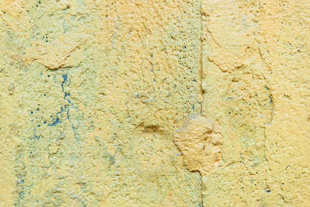 the texture of the old yellow boiled wall to the full screenの写真素材