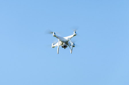 Quadcopter against a background of blue sky on the whole frameの写真素材