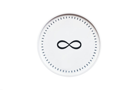 round white clock with infinity sign on white isolated backgroundの写真素材