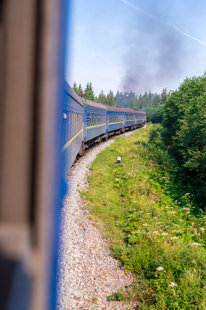 Travel, rest. View from the train window at the turn of the train, nature and treesの写真素材