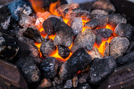 The hot embers of the fire on the whole frame. Melting of metal, we prepare shish kebab, warm up near the fire.の写真素材