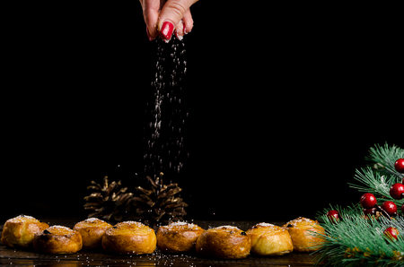 a female hand sprinkles biscuitsの写真素材