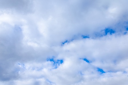 texture of a blue sky behind white clouds