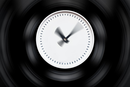 round white clock with blurred arrows on a dark isolated background