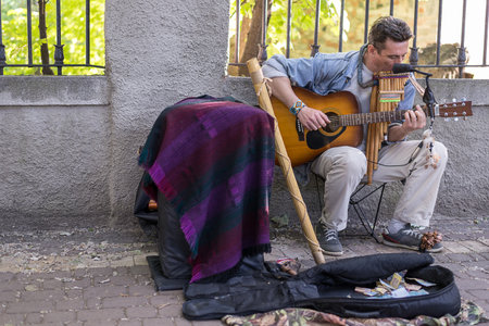 KIEV, UKRAINE - June 04, 2017. Street musician, man playing the guitar, outdoors